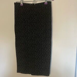 Black, stretchy pencil skirt with tiny white polka dots. XS.